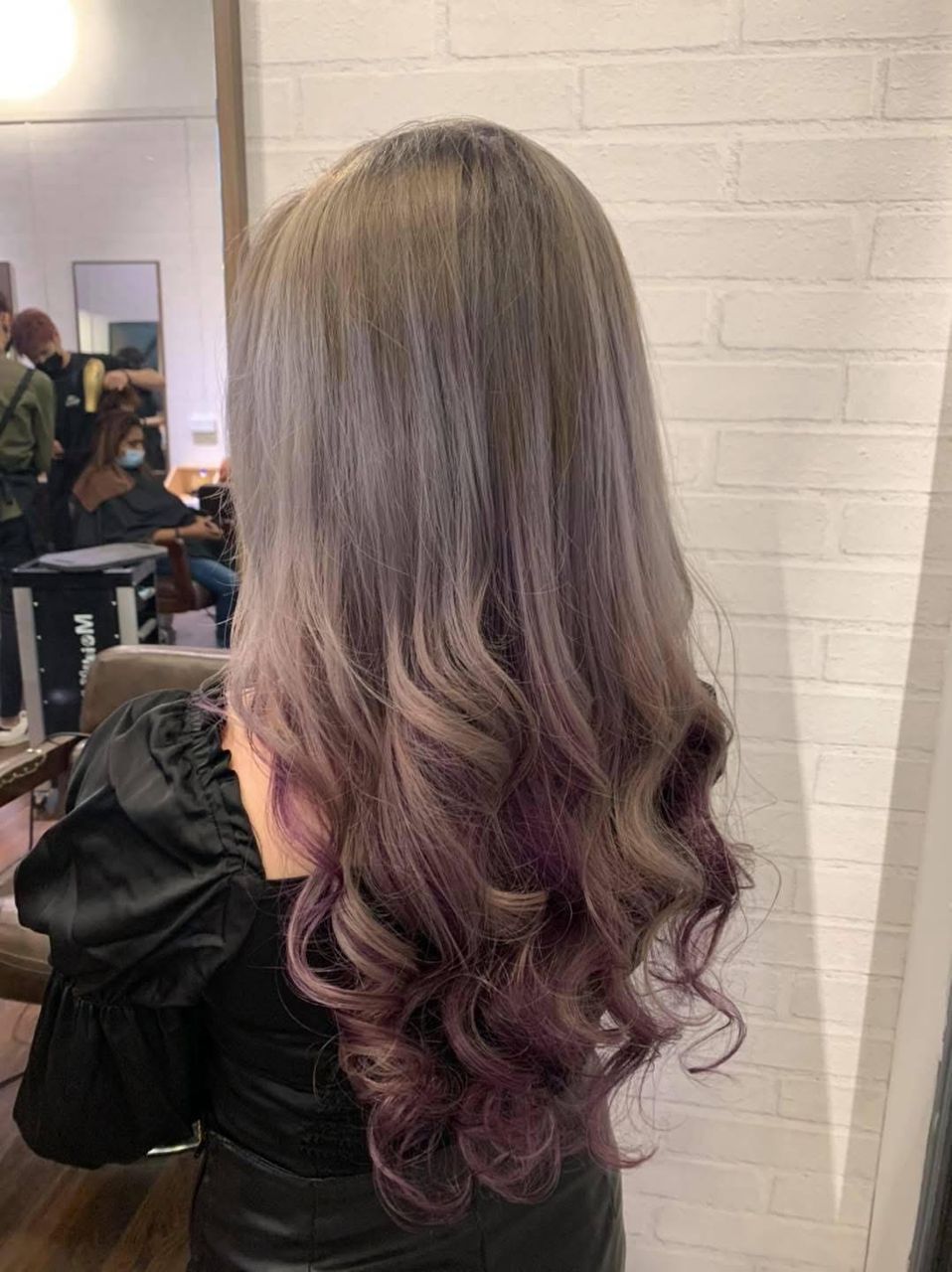 Glossy hair being shaped by a stylist